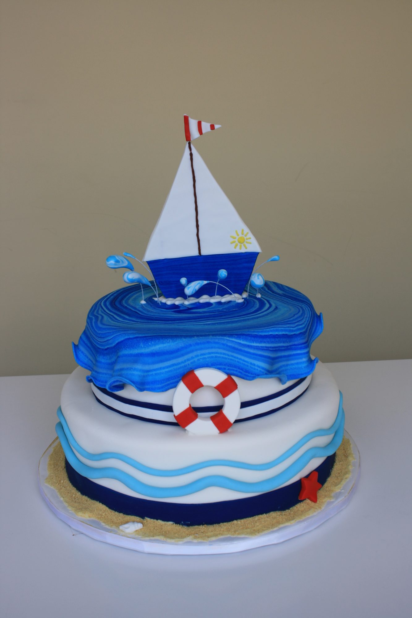 Sailboat on blue waves birthday cake